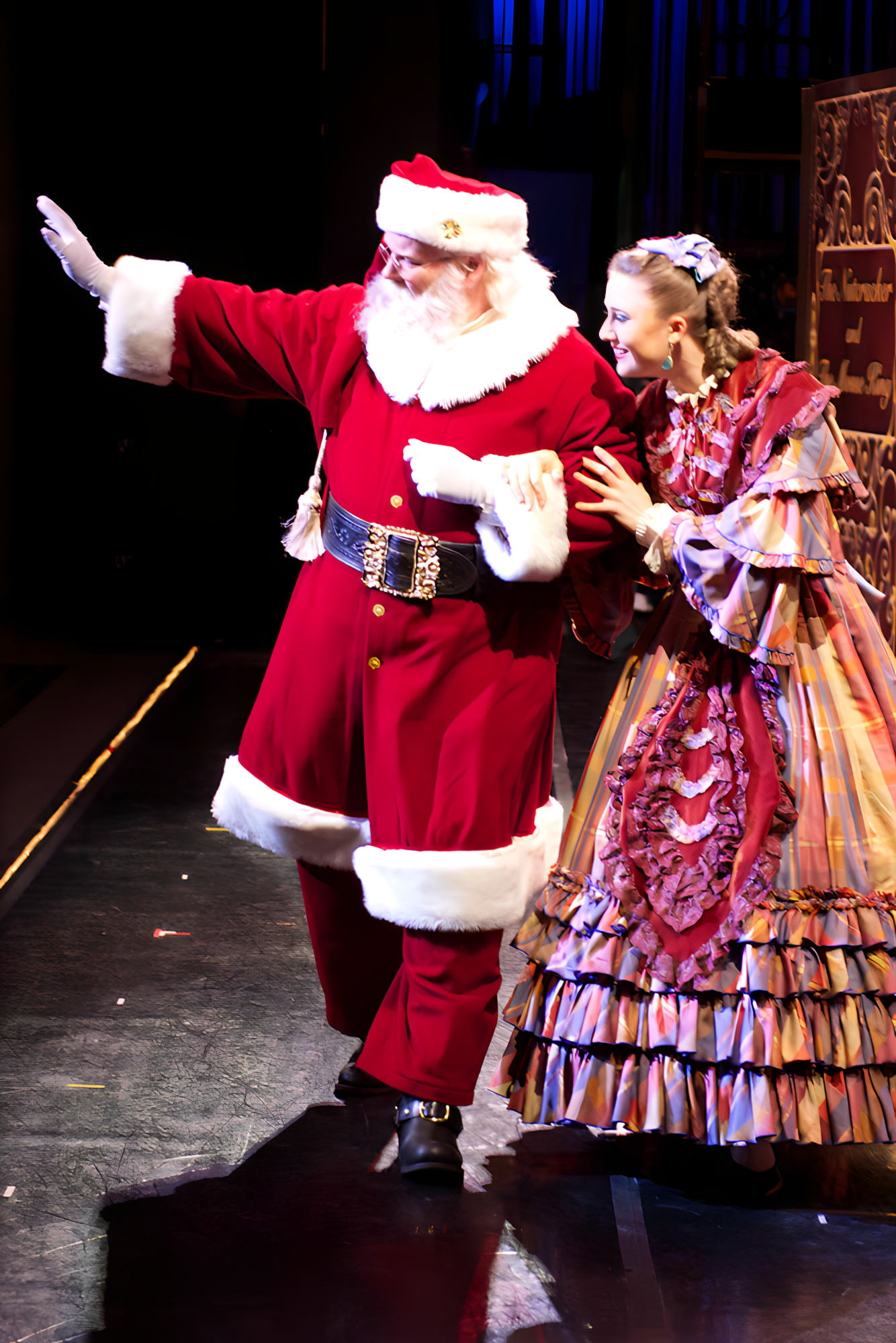 Santa “breaks the fourth wall” on stage with the Carolina Ballet and waves at the children in the audience.