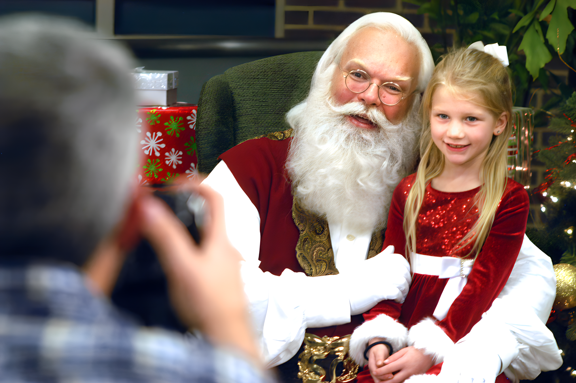 Santa seated with a young girl for a portrait